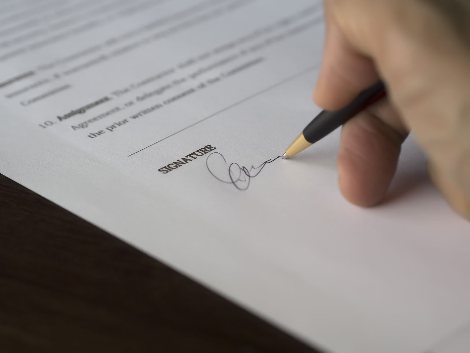 Pessoa assinando um contrato, representando a formalização de um contrato de convivência